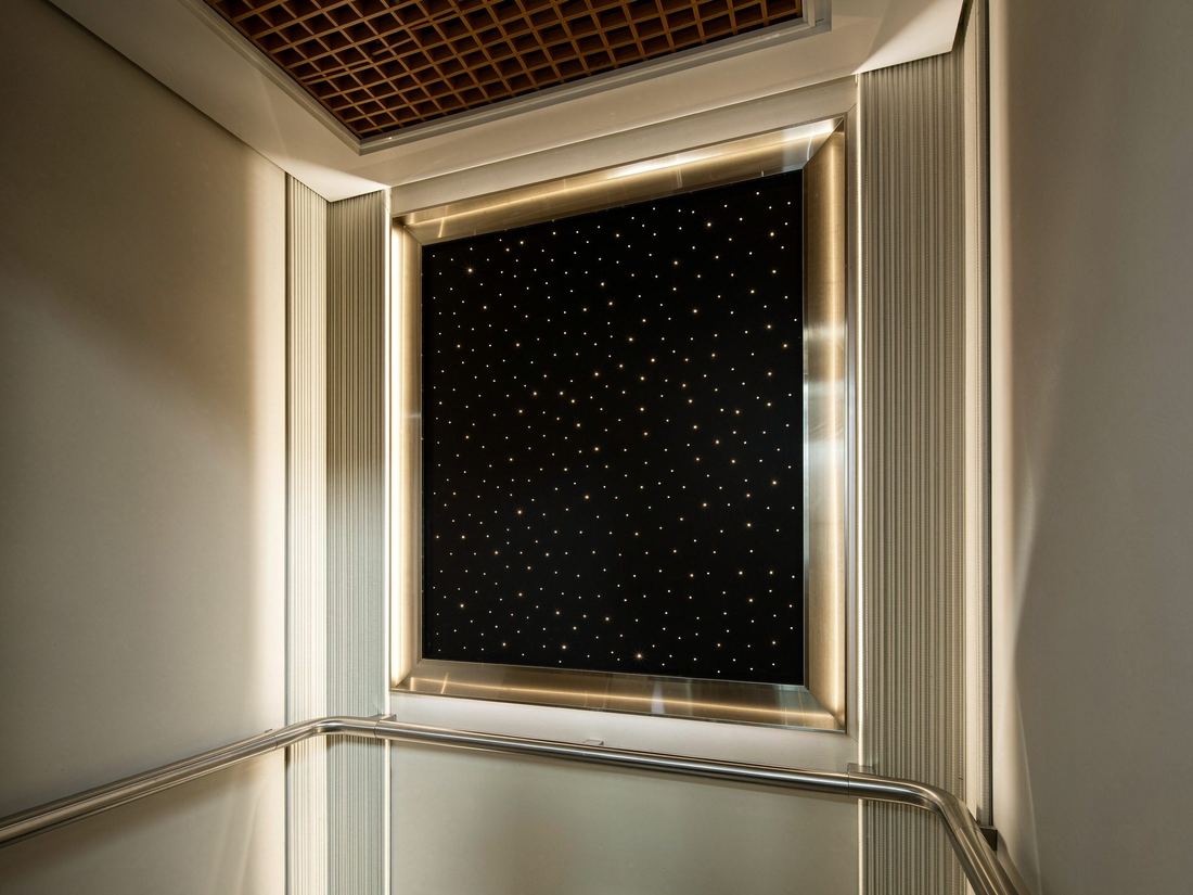 Starlit elevator ceiling panel with embedded warm LED points