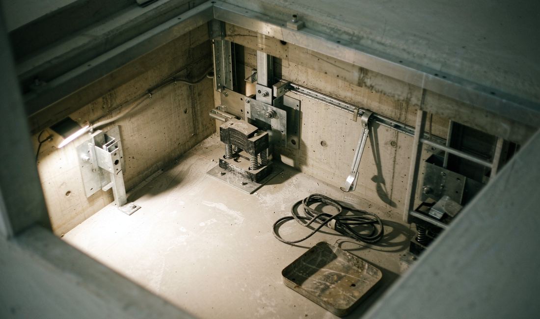 Empty elevator pit with steel mounting brackets before installation