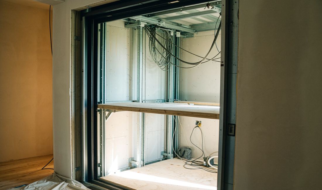 Steel guide rails and frame being installed inside an elevator shaft