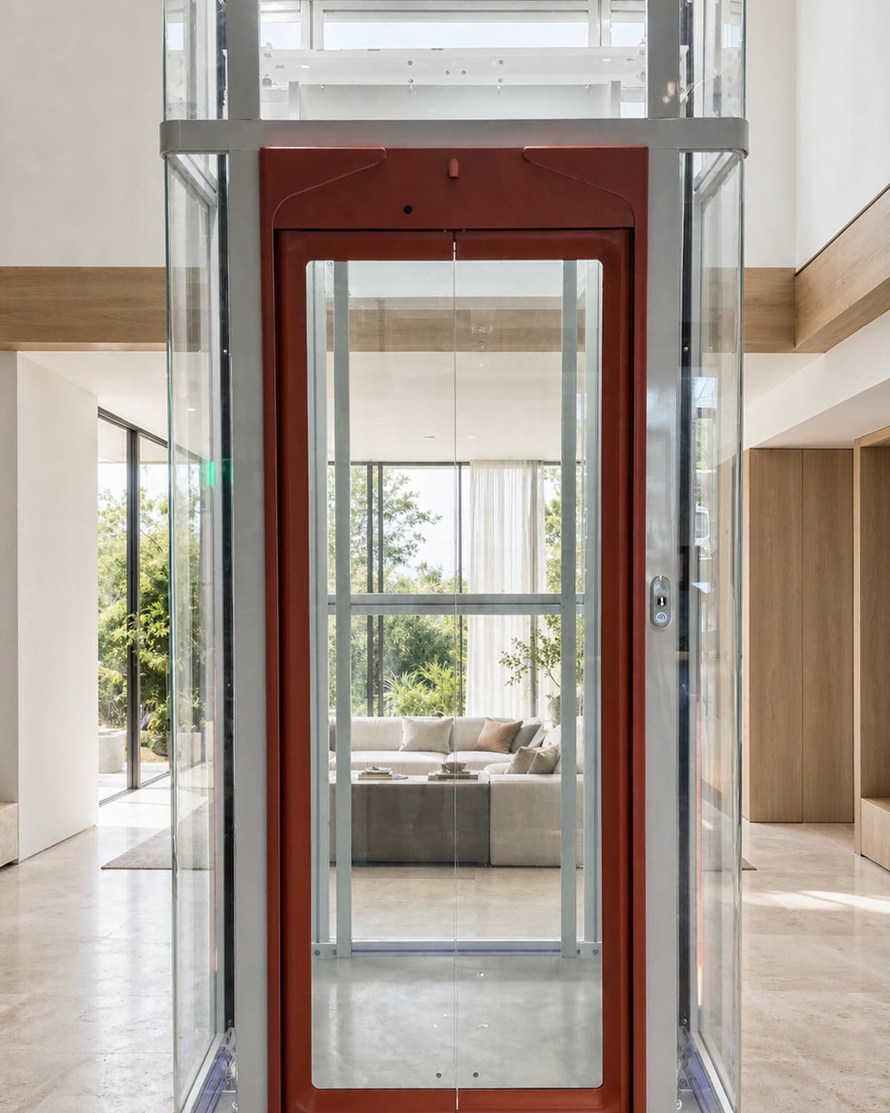 A SINNVO glass-shaft home elevator with a framed glass door, standing in a bright showroom