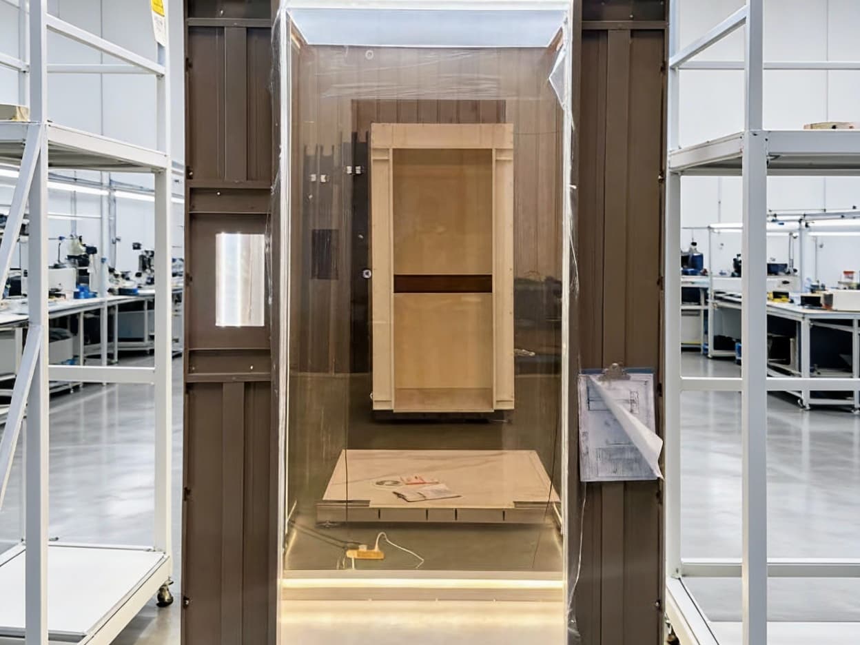 A SINNVO cabin in its frame in a clean, bright assembly workshop